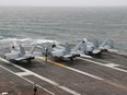 Three A F/A-18E Super Hornet fighter jet seen parked on the deck of the USS Nimitz Aircraft Carrier during a deployment to the South China Sea, Mid-Sea, Jan. 27, 2023.