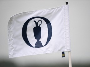 The claret jug logo is seen on a flag during a practice round for The 149th British Open Golf Championship at Royal St George's, Sandwich in south-east England on July 12, 2021.
