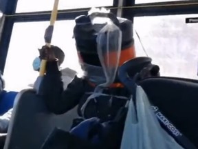 Screengrab of man wearing homemade protective headgear on TTC bus.