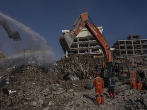 Excavators work at the site of buildings that collapsed during the earthquake in Kahramanmaras, Turkey, Friday, Feb. 17, 2023.