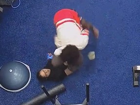 Screenshot of woman fighting off attacker at gym.