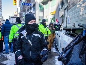 A file photo shows an unidentified Ottawa bylaw officer in the downtown core during last winter's convoy protest.