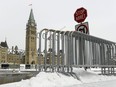 Ottawa city council has approved a motion to reopen Wellington Street to traffic over a year after it was closed off following the "Freedom Convoy." Fencing is seen on Parliament Hill in Ottawa, one year after the Freedom Convoy protests took place, on Friday, Jan. 27, 2023.