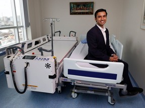 Jayiesh Singh, co-founder and CEO of Able Innovations, poses for a photo at the Saint Vincent Hospital with his robotic equipment invented to transfer patients from beds to stretchers without the need for staff to pick them up.