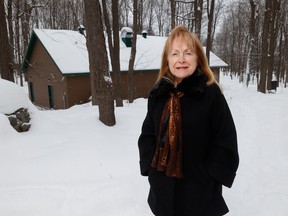 Madeleine Meilleur, general manager of Muséoparc Vanier, stands in front of the Vanier Sugar Shack, whose rebuilding is nearing completion.