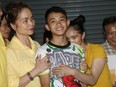 Relatives of Duangphet "Dom" Phromthep, one of the boys rescued from the flooded cave in northern Thailand, greet him as he arrives home in the Mae Sai district, Chiang Rai province, northern Thailand, July 18, 2018.