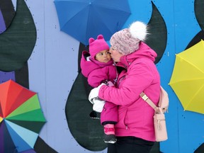 In matching pink snowsuits, Tara Williams and her young daughter Amya Williams, 20 months, were picture perfect beside the sliding hill at Winterlude in Jacque-Cartier North Park Thursday.