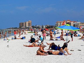 People gather on Clearwater Beach during spring break in Clearwater, Florida on March 18, 2020.