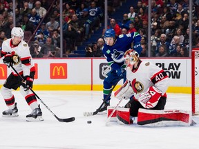 Ottawa Senators defenseman Nick Holden (5) watches as goalie Mads Sogaard (40) makes a save on Vancouver Canucks forward Andrei Kuzmenko (96) in the third period at Rogers Arena.