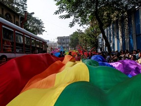 Participants hold a rainbow flag during a gay pride parade, which is promoting gay, lesbian, bisexual and transgender rights, in Mumbai, India, Jan. 31, 2015.