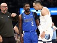 Dallas Mavericks head coach Jason Kidd (left) talks with guard Kyrie Irving (2) as Memphis Grizzlies forward Dillon Brooks (24) listens in during the first half at FedExForum.