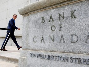 Tiff Macklem walks outside the Bank of Canada building