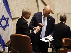 The new speaker of the knesset, Amir Ohana, receives his gavel as Israel's new right-wing government is sworn in at the Knesset, Israel's parliament, Thursday, Dec. 29, 2022, in Jerusalem.