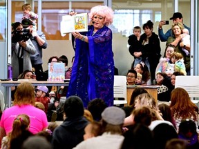 Conni Smudge reads a story to a crowd during Drag Queen Story Time at the Coquitlam City Centre library in Coquitlam, B.C., Jan. 14, 2023.
