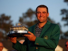 Golf - The Masters - Augusta National Golf Club - Augusta, Georgia, U.S. - April 10, 2022 Scottie Scheffler of the U.S. poses in his green jacket with the trophy after winning The Masters.