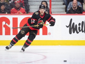 Ottawa, Ontario, CAN; Ottawa Senators right wing Alex DeBrincat (12) shoots the puck in the second period against the Chicago Blackhawks at the Canadian Tire Centre.