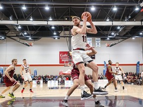 Grant Shephard of the Ravens collects a rebound of a missed shot against the Gee-Gees in the Ontario University Athletics men's basketball final on Saturday night.