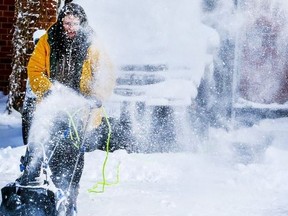 Donna Barron clears snow in Scarborough on Feb. 18, 2022.