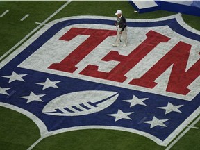 Groundskeeper George Toma walks on the turf prior to the NFL Super Bowl 57 football game between the Kansas City Chiefs and the Philadelphia Eagles, Sunday, Feb. 12, 2023, in Glendale, Ariz.
