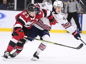 Will Gerrior (23) of the 67's and Beckett Sennecke of the Generals battle for position in the first period of Thursday's series opener in Gatineau.