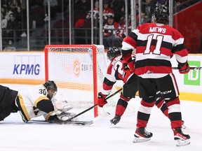 Will Gerrior of the Ottawa 67's works in tight against Kingston Frontenacs goalie Ivan Zhigalov at the Arena at TD Place on Wednesday, March 1, 2023.