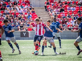 OTTAWA: Atlético Ottawa host the Halifax Wanderers for their home opener at a TD Place Saturday, April 15, 2023. The pay what you can event was also a fundraiser for the CHEO Foundation. Ottawa's Noah Timothy Verhoeven gets the ball from Halifax Wanderers.