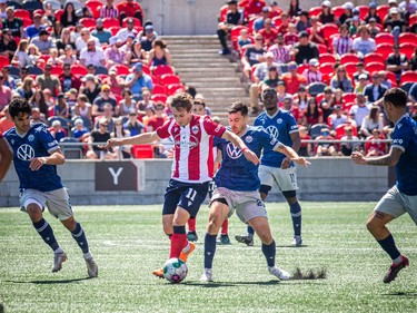 Atlético Ottawa host the Halifax Wanderers for their home opener at a TD Place Saturday, April 15, 2023. The pay what you can event was also a fundraiser for the CHEO Foundation.  Ottawa's Noah Timothy Verhoeven gets the ball from Halifax Wanderers.