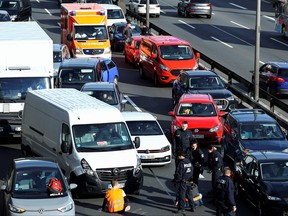 An ambulance is stuck in traffic jam as activists of the "Letzte Generation" (Last Generation) block a highway to protest for climate councils, speed limit on highways as well as for affordable public transport, in Berlin, Germany, April 24, 2023.