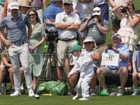 Mackenzie Hughes, of Canada, watches as his son Kenton, 5, tees off on the fourth hole during the par 3 contest at the Masters golf tournament at Augusta National Golf Club on Wednesday, April 5, 2023, in Augusta, Ga.