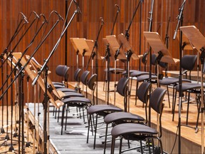 Empty orchestra stage with chairs and microphones