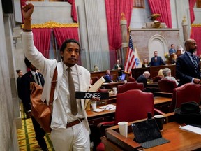 Justin Jones caries his name tag after a vote at the Tennessee House of Representatives to expel him for his role in a gun control demonstration at the statehouse last week, in Nashville, Thursday, April 6, 2023.