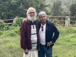 Anant Anantaraman, left, and his friend Manu Hari stand on the grounds of the school that Anantaraman founded in memory of his wife and two children, who died when Air India Flight 182 exploded over the Atlantic Ocean in June 1985. The photo was taken in September 2022.