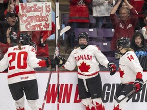 Canada forward Sarah Fillier (10) is congratulated by teammates forward Sarah Nurse (20) and defender Renata Fast (14) after scoring on Switzerland during second period IIHF Women's World Hockey Championship semi-final hockey action in Brampton, Ont., on Saturday April 15, 2023.