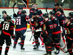 Ottawa Senators right wing Claude Giroux (28) is swarmed by teammates as they help him celebrate his 1,000th career point after assisting on a goal against the Carolina Hurricanes in the first period at the Canadian Tire Centre on Monday, April 10, 2023.