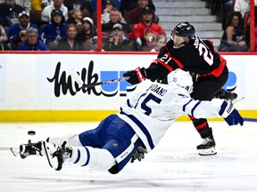 Senators winger Mathieu Joseph (21) takes a shot as Maple Leafs defenceman Mark Giordano dives in a bid to block it during the second period.