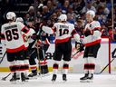 Senators centre Tim Stutzle (18) celebrates with defenceman Jake Sanderson (85), winger Brady Tkachuk and others after scoring a second-period goal against the Sabres in the team's season finale on Thursday night.