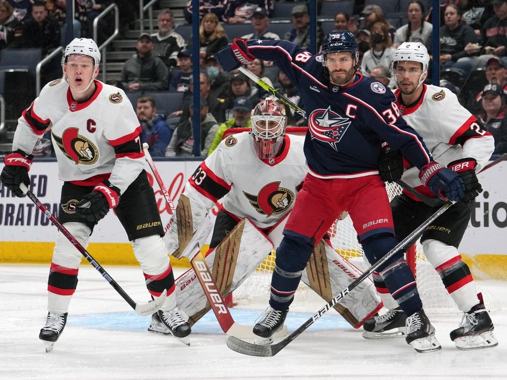 Columbus Blue Jackets centre Boone Jenner and Ottawa Senators defenceman Artem Zub battle for position in front of Ottawa Senators goaltender Cam Talbot during the first period.