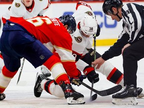 Senators centre Patrick Brown (38) and the Panthers’ Colin White face off during the first period of Thursday’s game.