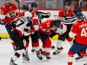 Panthers winger Givani Smith (54) and Senators centre Mark Kastelic (47) tangle during the third period of Thursday's hotly contested game at Sunrise, Fla.
