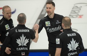 Team Canada (L-R) 3rd. Mark Nichols, 2nd. E.J.Harnden, skip Brad Gushue, lead Geoff Walker shake hands after team Canada defeat team Japan 6-3 in draw 7.