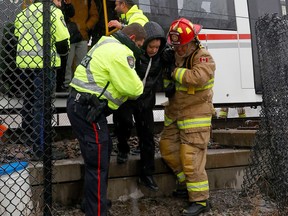 Ottawa's LRT shut down due to a power issue Wednesday morning as a freezing rainstorm hit the capital. Ottawa Fire Fighters and Ottawa Police cut a hole in the fence near Lees Station to help get riders evacuated off the train.