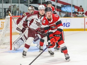 Logan Morrison of the 67's works for position against Shawn Spearing (7) of the Petes.