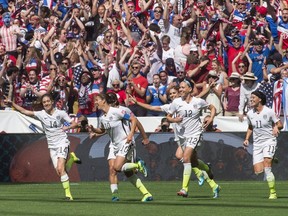 United States players (left to right) Morgan Brian (14), Carli Lloyd (10), Lauren Holiday (12) and Ali Krieger (11) celebrate Lloyd's second goal against Japan during first half final game soccer action at the FIFA Women's World Cup in Vancouver on Sunday, July 5, 2015. Canada Soccer says it was not consulted about the joint bid by the U.S. and Mexico to host the 2027 Women's World Cup.