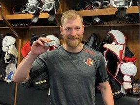 Claude Giroux with the puck he used to score his 1,000th career.