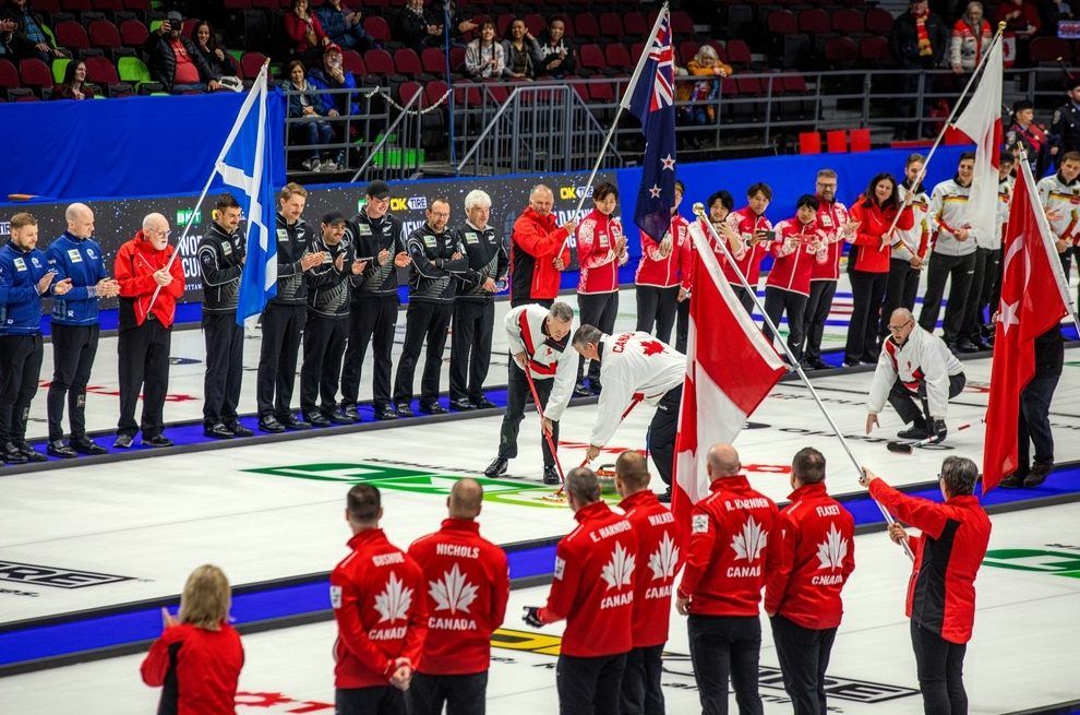 Canada’s 1993 world champions perform the throw of the ceremonial first rock of the world championship in Ottawa on Saturday afternoon.