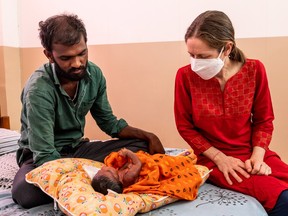 Dr. Megan Doherty checks on the 15-day-old Mallesh at the Mandara Hospice for Children in Hyderabad, India, March 16, 2022.