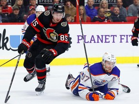 Ottawa Senators defenceman Jake Sanderson takes down Edmonton Oilers centre Connor McDavid during a February 2023 game.