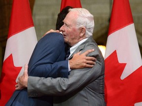 Then Governor General of Canada David Johnston Prime Minister Justin Trudeau embrace on during a a farewell reception in Ottawa on Thursday Sept. 28, 2017.