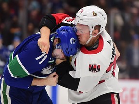 Mark Borowiecki fights the Vancouver Canucks’ Zack MacEwen in September 2019.