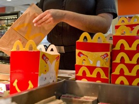 In this file photo, a McDonald's manager helps pack happy meals at the restaurant in London, Ont. on Aug. 19, 2016.